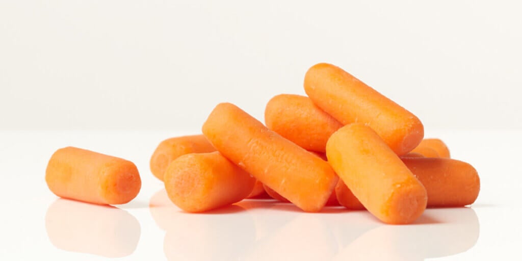 Baby Carrots, grocery store produce, on a blank background.