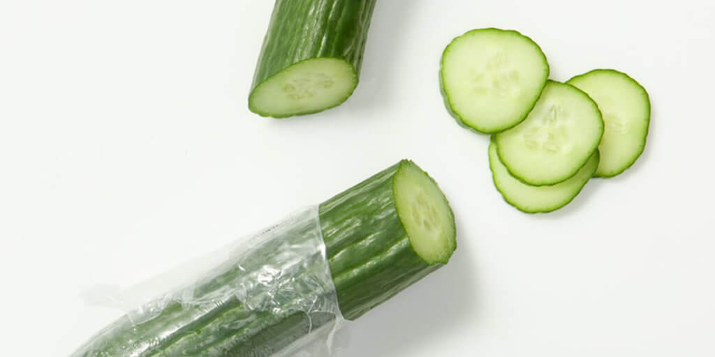 English cucumbers, grocery store produce, on a blank background.