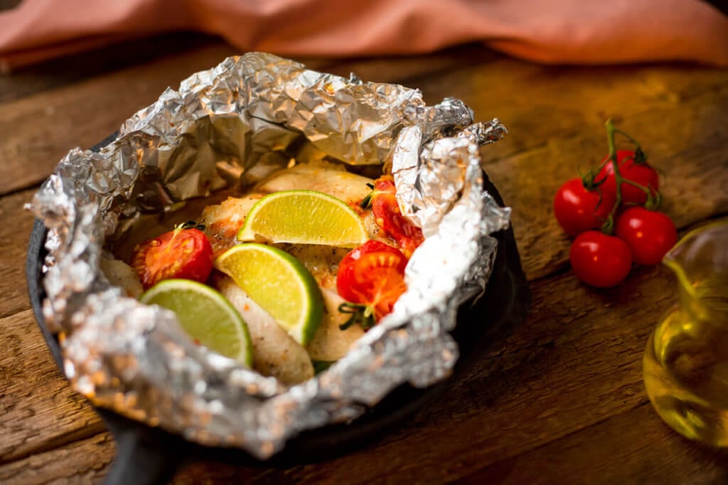 Baked fish in foil stock photo