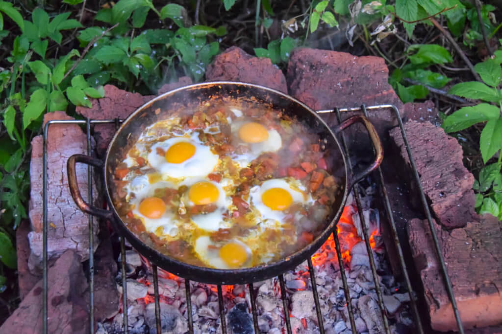 scrambled eggs on a campfire camping in the nature Shakshouka cuisine