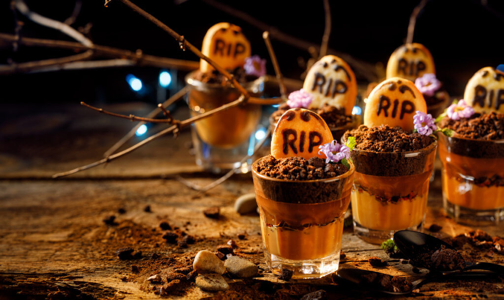 Graveyard chocolate mousse cups with tombstone cookies. Halloween dessert