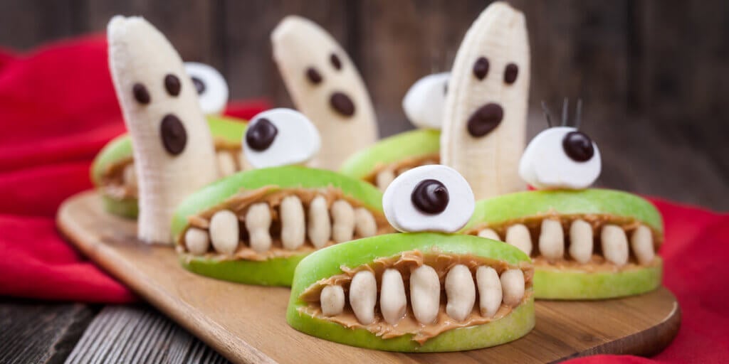 Funny halloween eadible monsters scary food healthy vegetarian snack dessert recipe for party decoration.