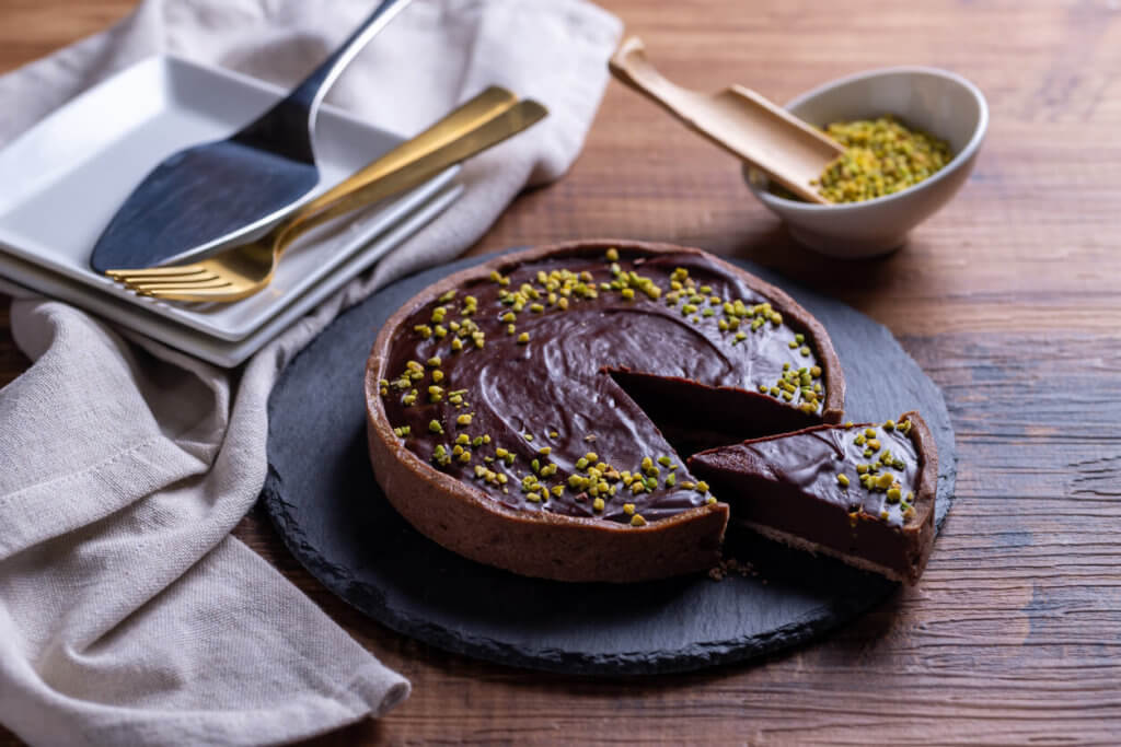 Chocolate tart made of loose dough on a wooden table.