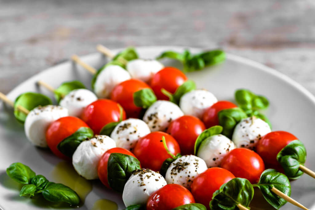 Healthy appetizer - caprese salad with tomato and mozzarella.