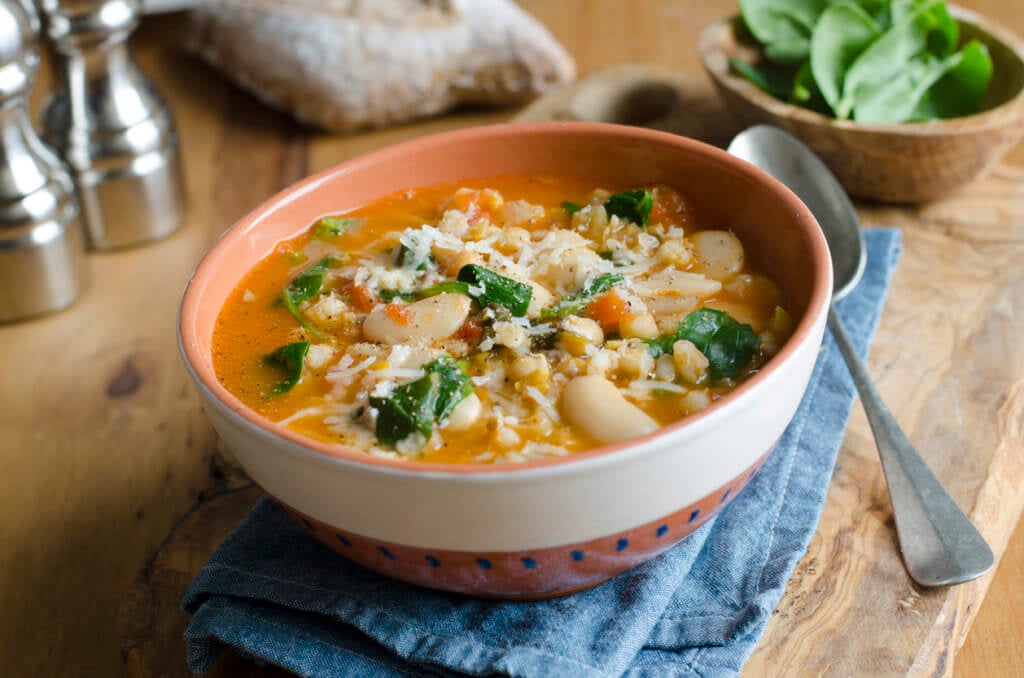Pearl barley, butter bean and chickpea soup topped with grated Parmesan.
