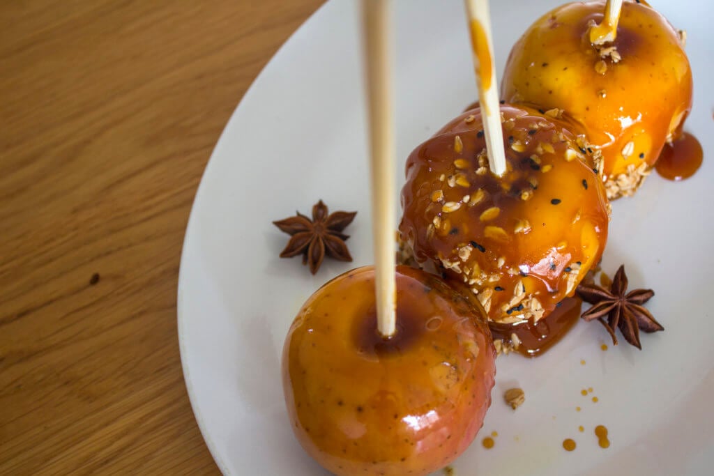 Festive caramel apples on sticks. 