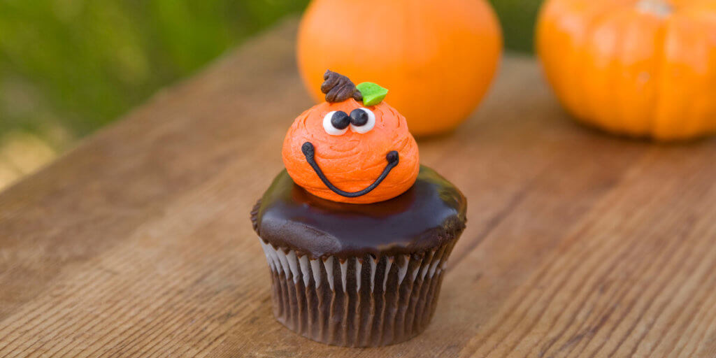 "Pumpkins and cupcake on dining table, the perfect homemade Halloween.