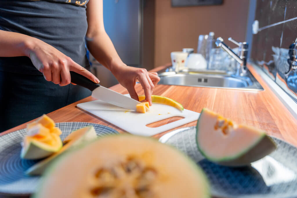 Preparing cantaloupe melon in serving portions.
