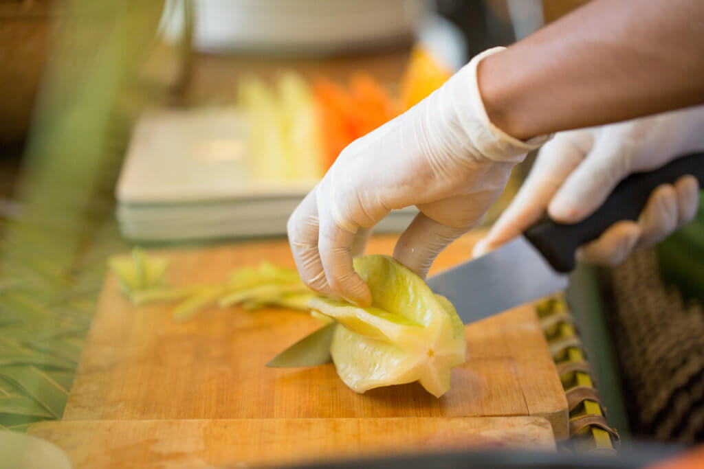 Chef cutting starfruit