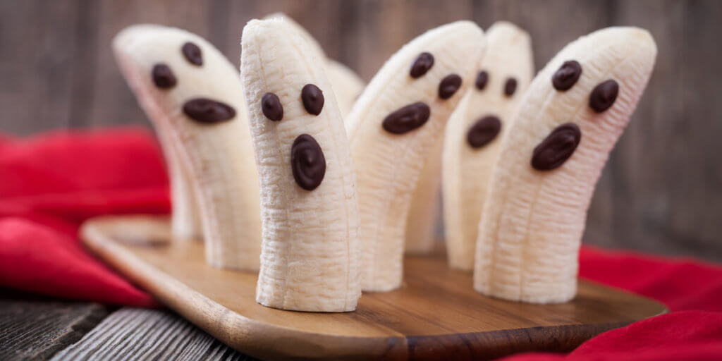Homemade halloween scary banana ghosts monsters with chocolate faces.