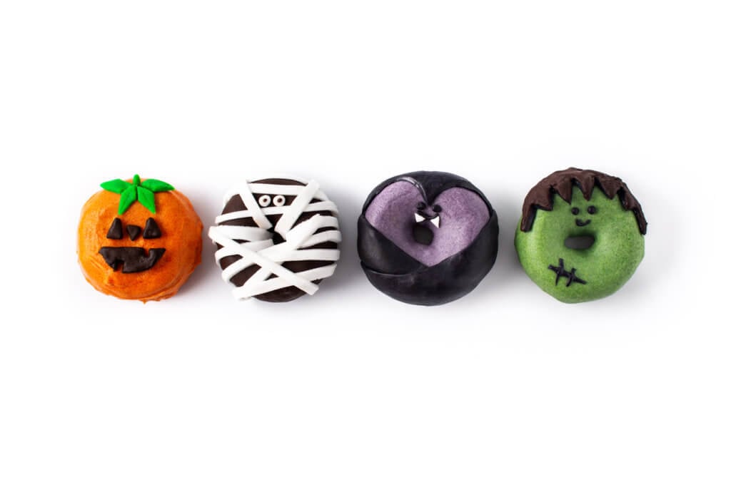 Assortment of Halloween donuts isolated on white background.