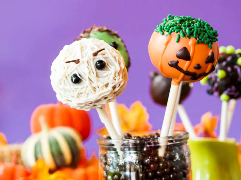 Halloween gourmet cake pops with purple background.