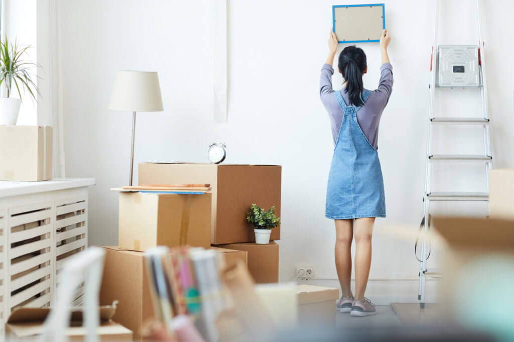 Woman Unpacking Boxes in New Home