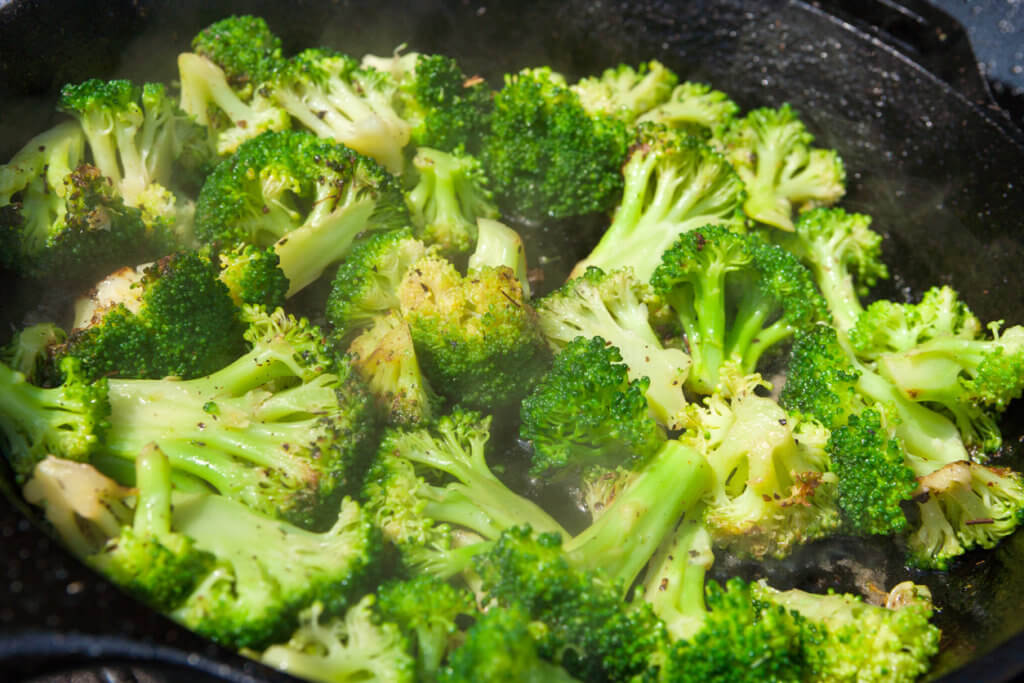 Sauted Broccoli in cast iron skillet on barbecue
