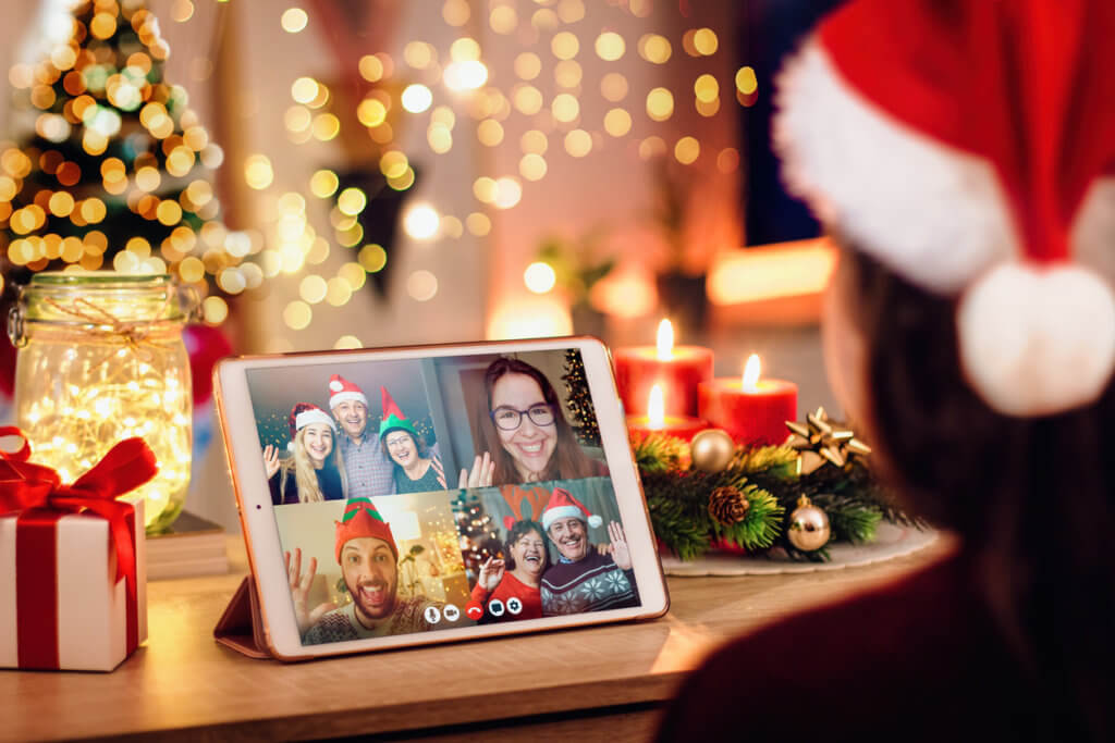 Girl having a Christmas video call with her happy family. 