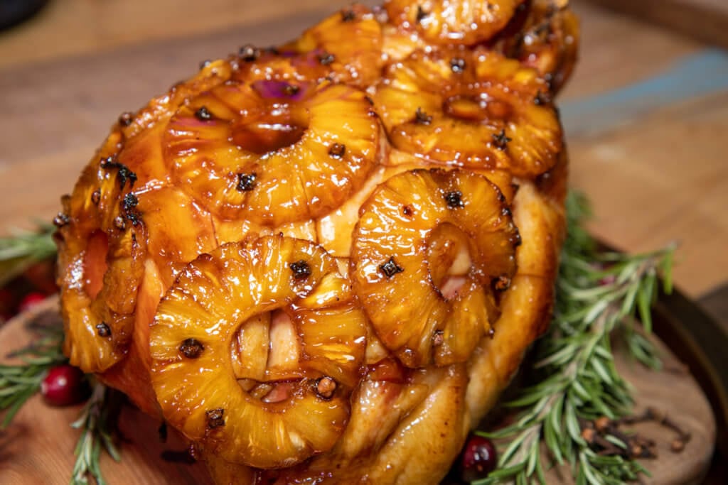 A delicious pineapple glazed ham in a holiday setting.