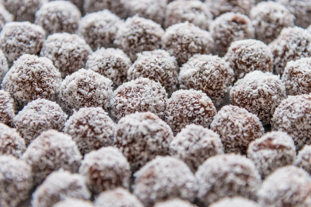 A lot of rum balls, made of chocolate, rum and coconut.