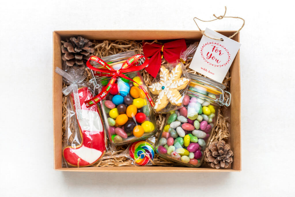 Handmade care package, seasonal gift box with candies, gingerbread, xmas deco.