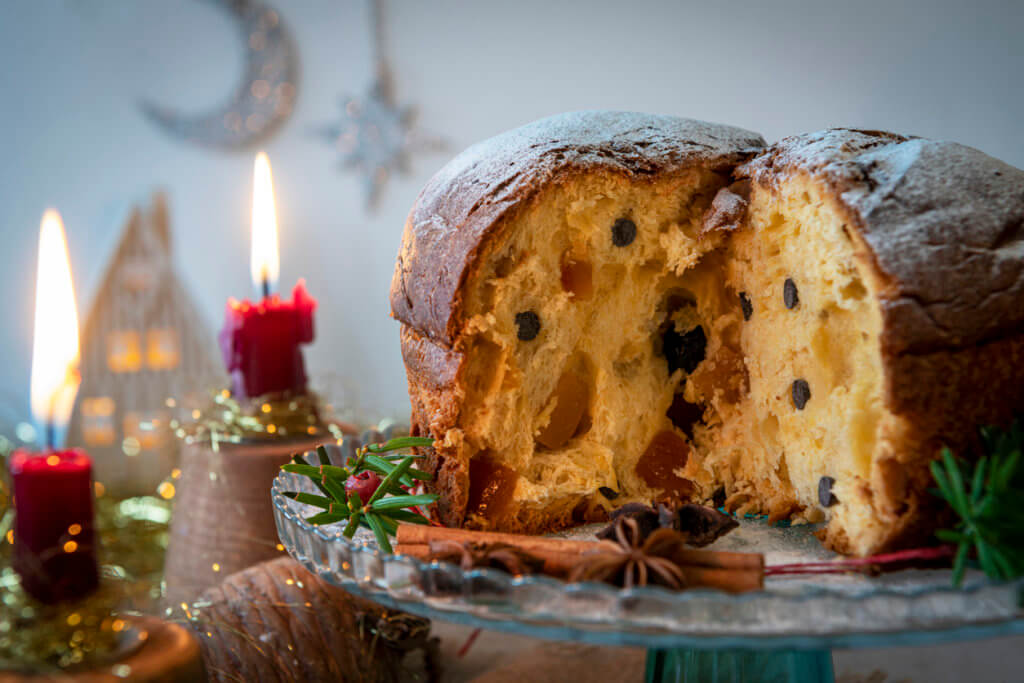 A traditional panettone, the famous italian Christmas cake on a table. 