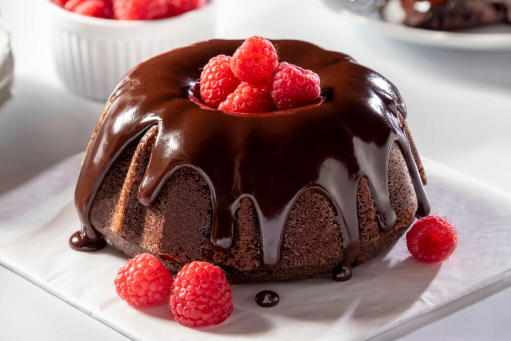 Beautiful mini chocolate bundt cake with chocolate ganache and raspberries.