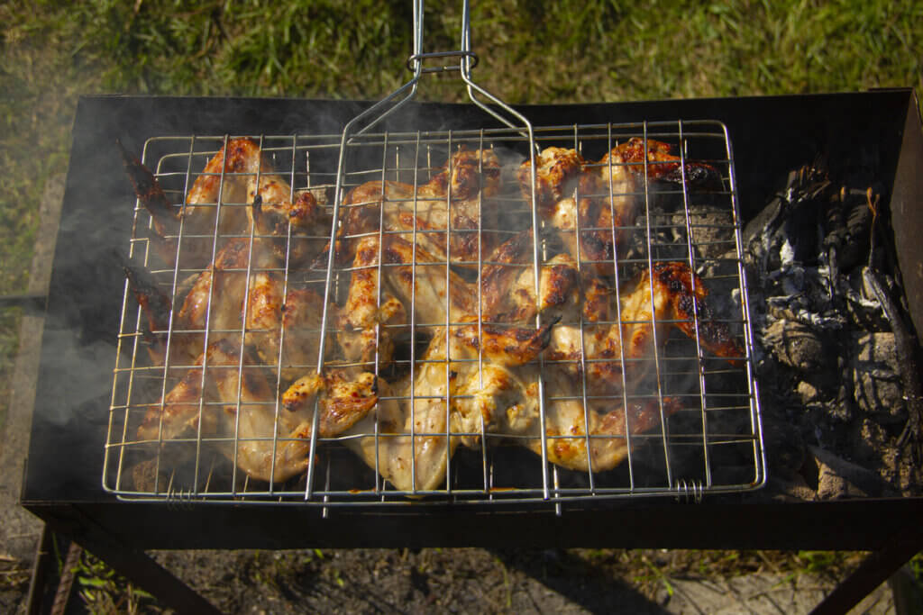 delicious chicken wings are cooked on the grill