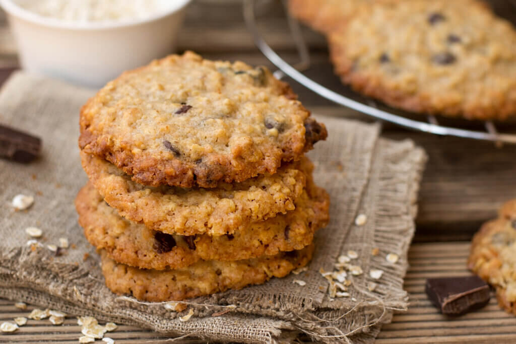 Sweet oatmeal cookies with chocolate served with milk
