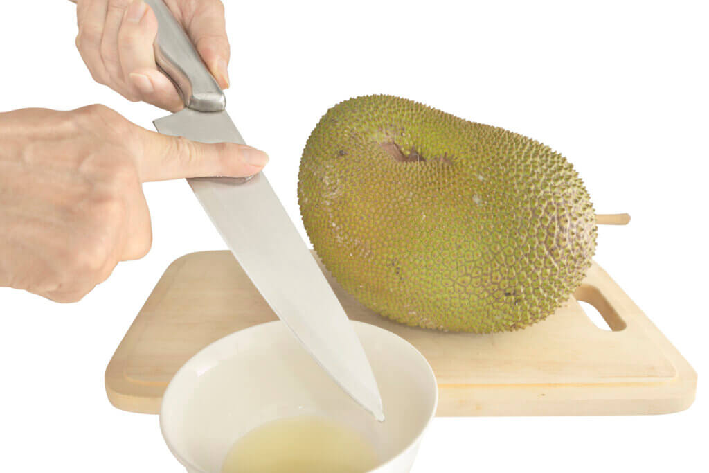 Anointing silver knife before cutting Jackfruit