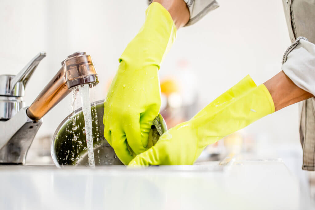 Washing Dishes With Protective Gloves