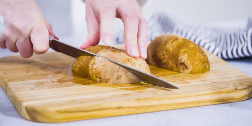 Cutting potato wedges.