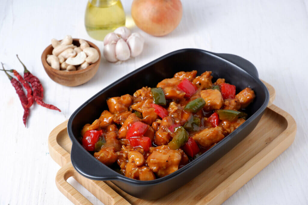 Kung Pao chicken, stir-fried traditional Chinese sichuan dish,with chicken, peanuts, vegetables and chili peppers.