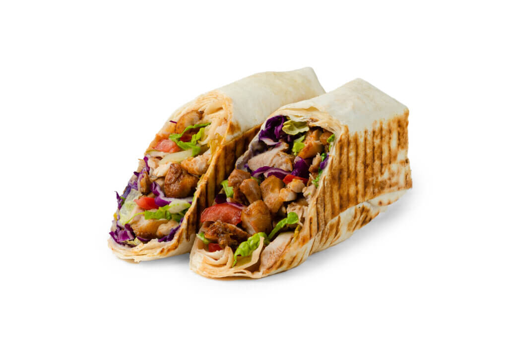 shawarma with chicken, lettuce and tomato cut on a white background
