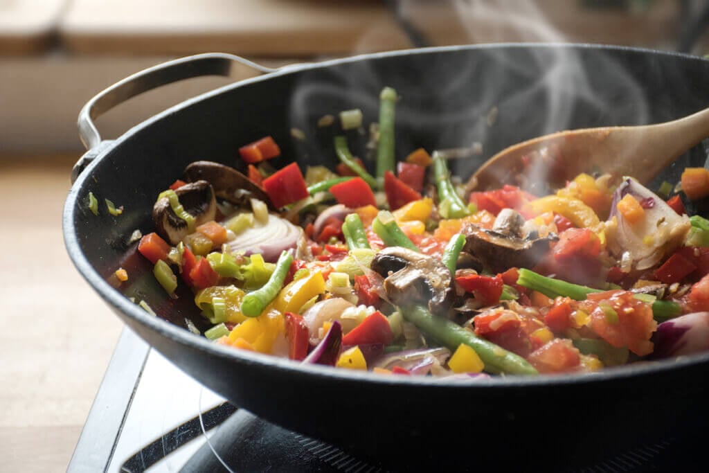 steaming mixed vegetables in the wok, asian style cooking