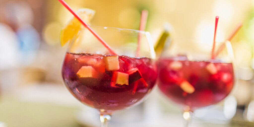 Two refreshing glasses of sangria with fruits, waiting to be savored.