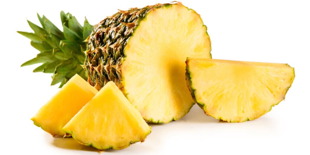 A cut pineapple with three slices.