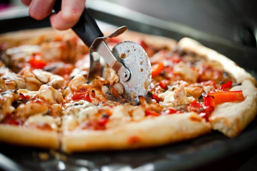 Homemade Pizza and pizza cutter.