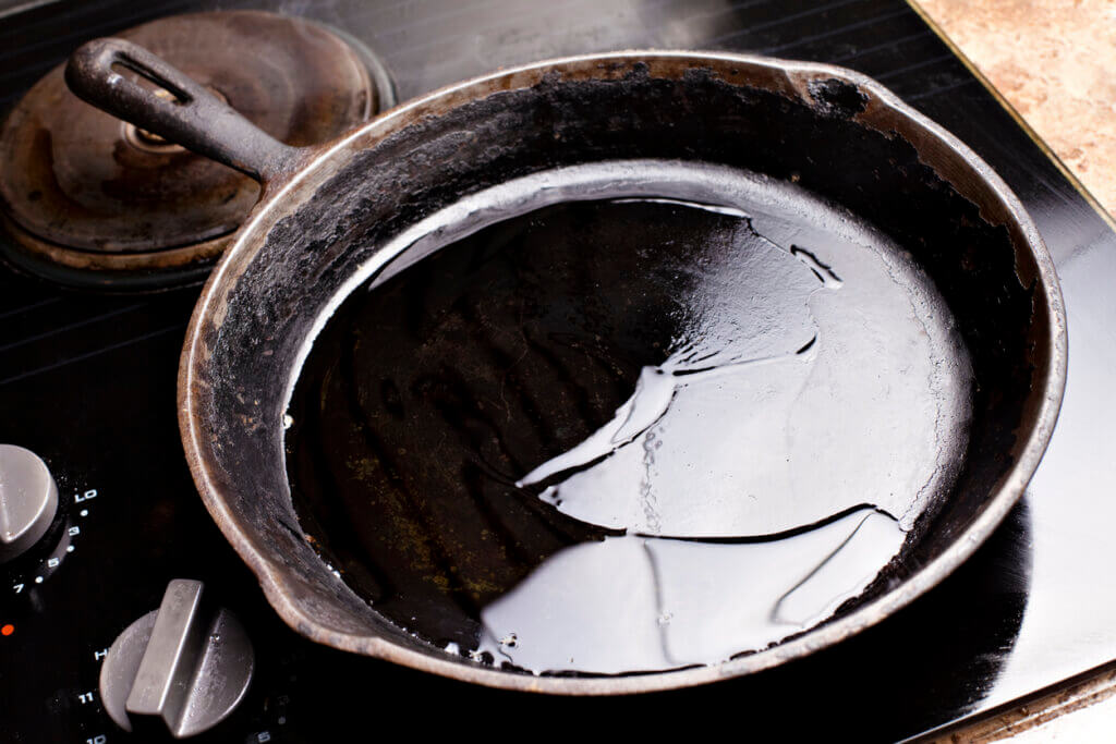 Old cast iron skillet with oil