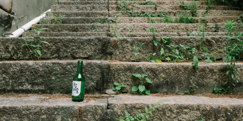 Chamisul soju bottle on the steps on the streets of incheon in south korea