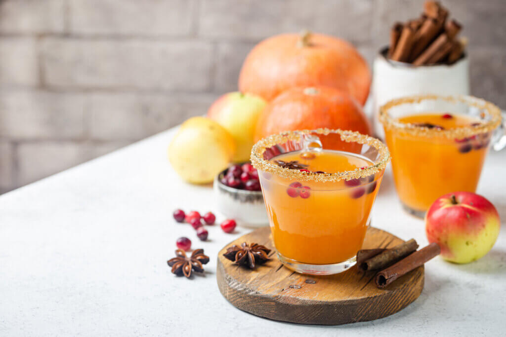 Spicy hot pumpkin punch or sangria in a glass with apple, cinnamon, anise. 