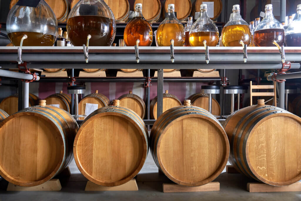 Wide shot of whiskey barrel in cellar.