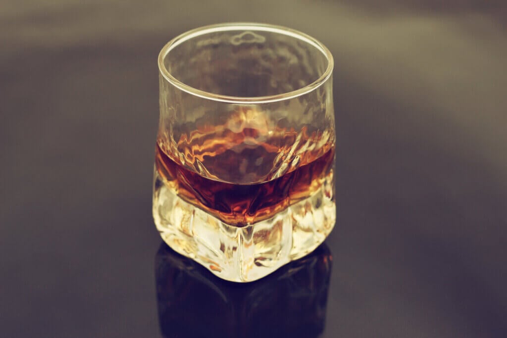 Straight bourbon whisky on a table.