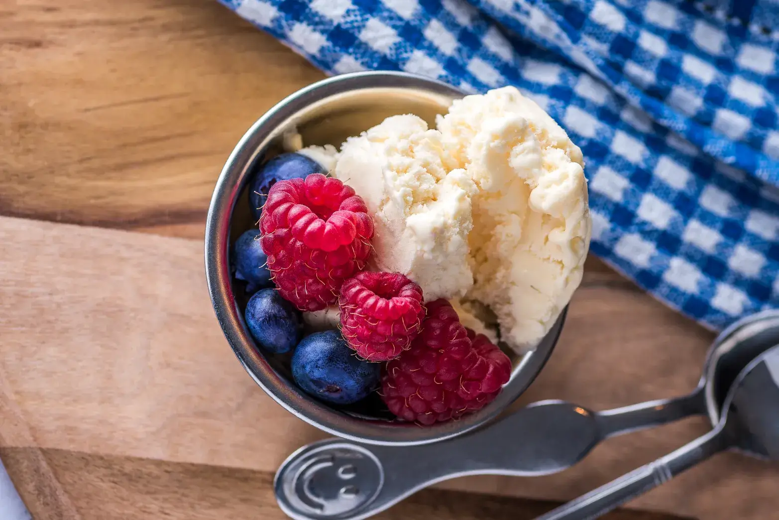 bowl of ice cream with blueberries and raspberries