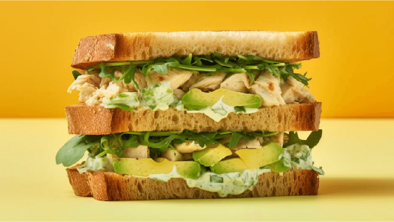 chicken salad sandwich with avocado and spinach