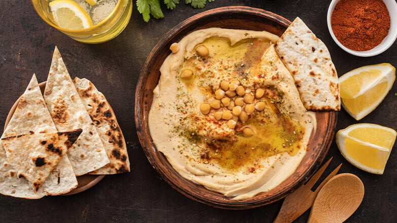 Pair pita bread with hummus for a tasty snack. 