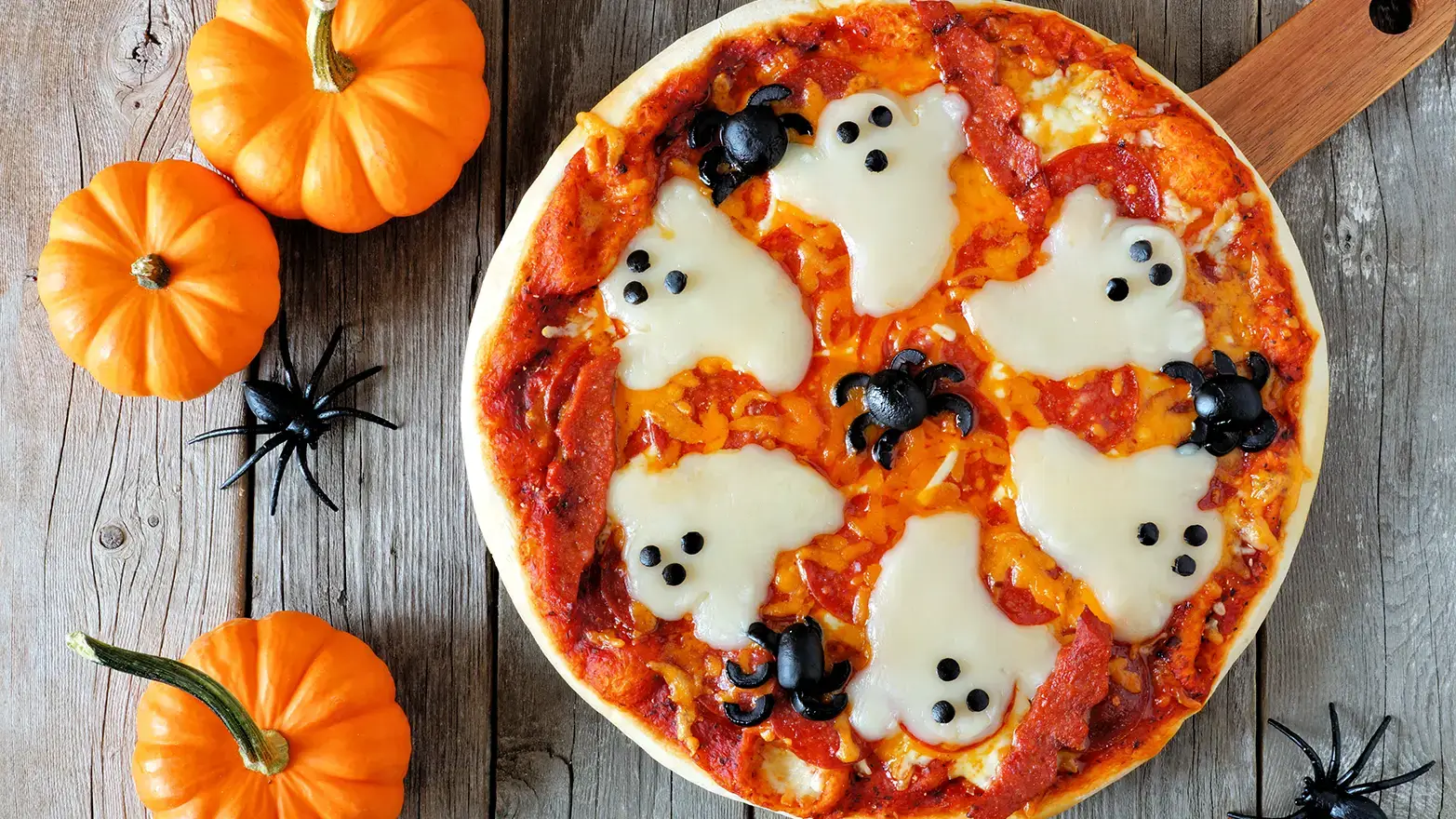 Halloween pizza with ghost mozzarella and black olive spiders