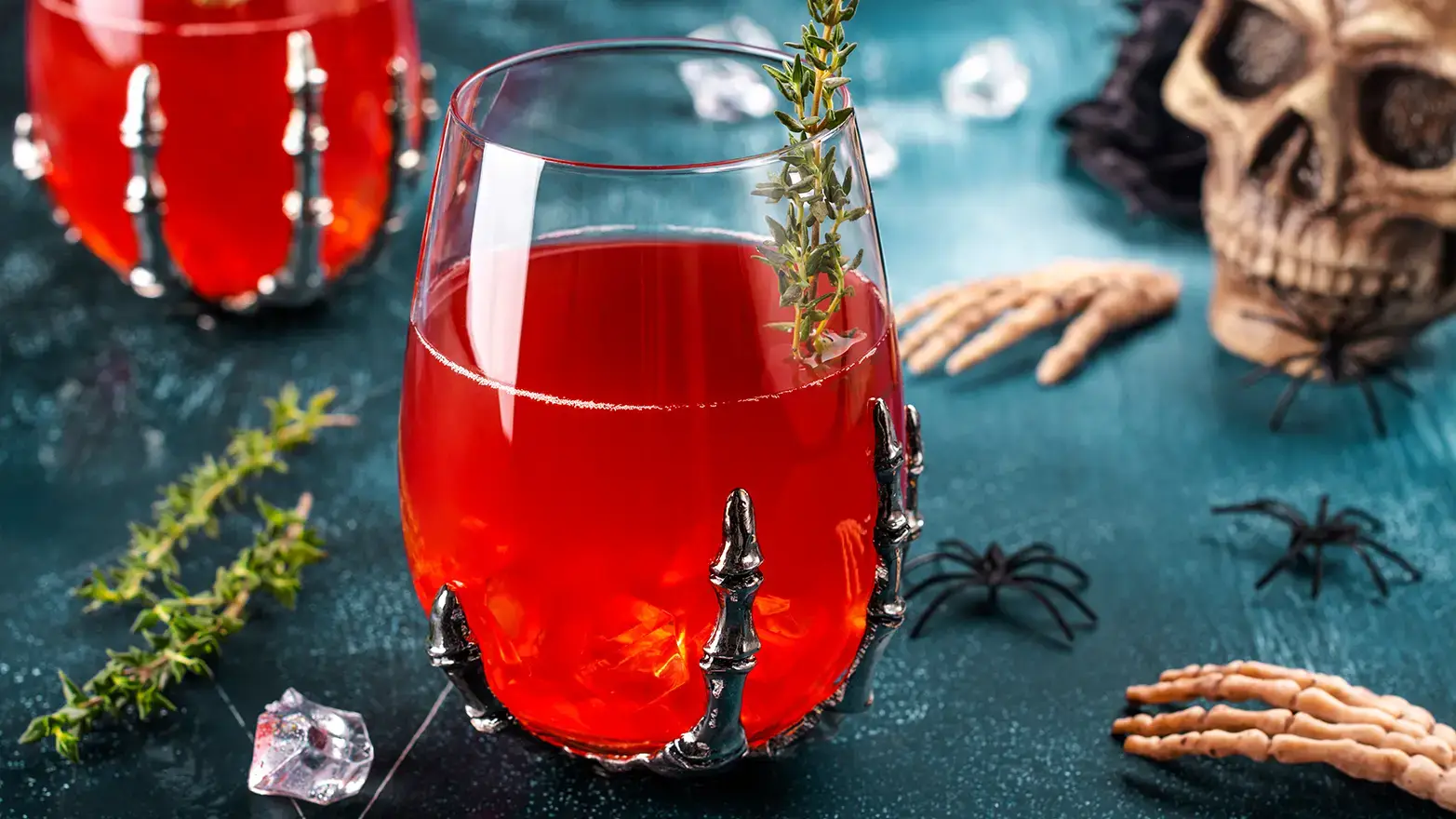 Red punch served in spooky skeleton glass