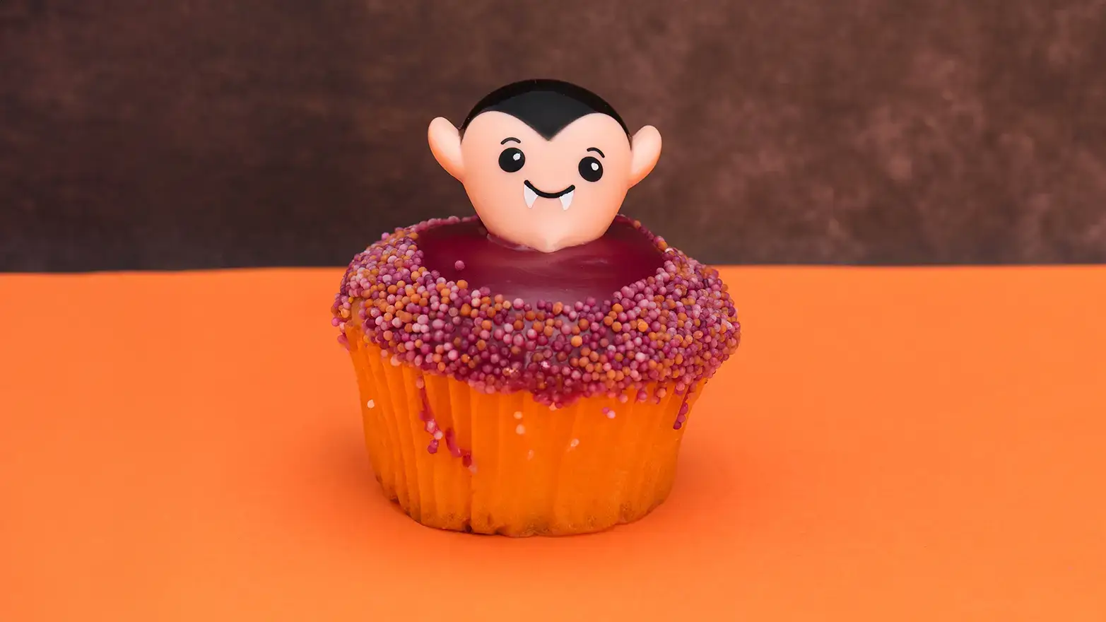 red velvet cupcake with dracula head on top