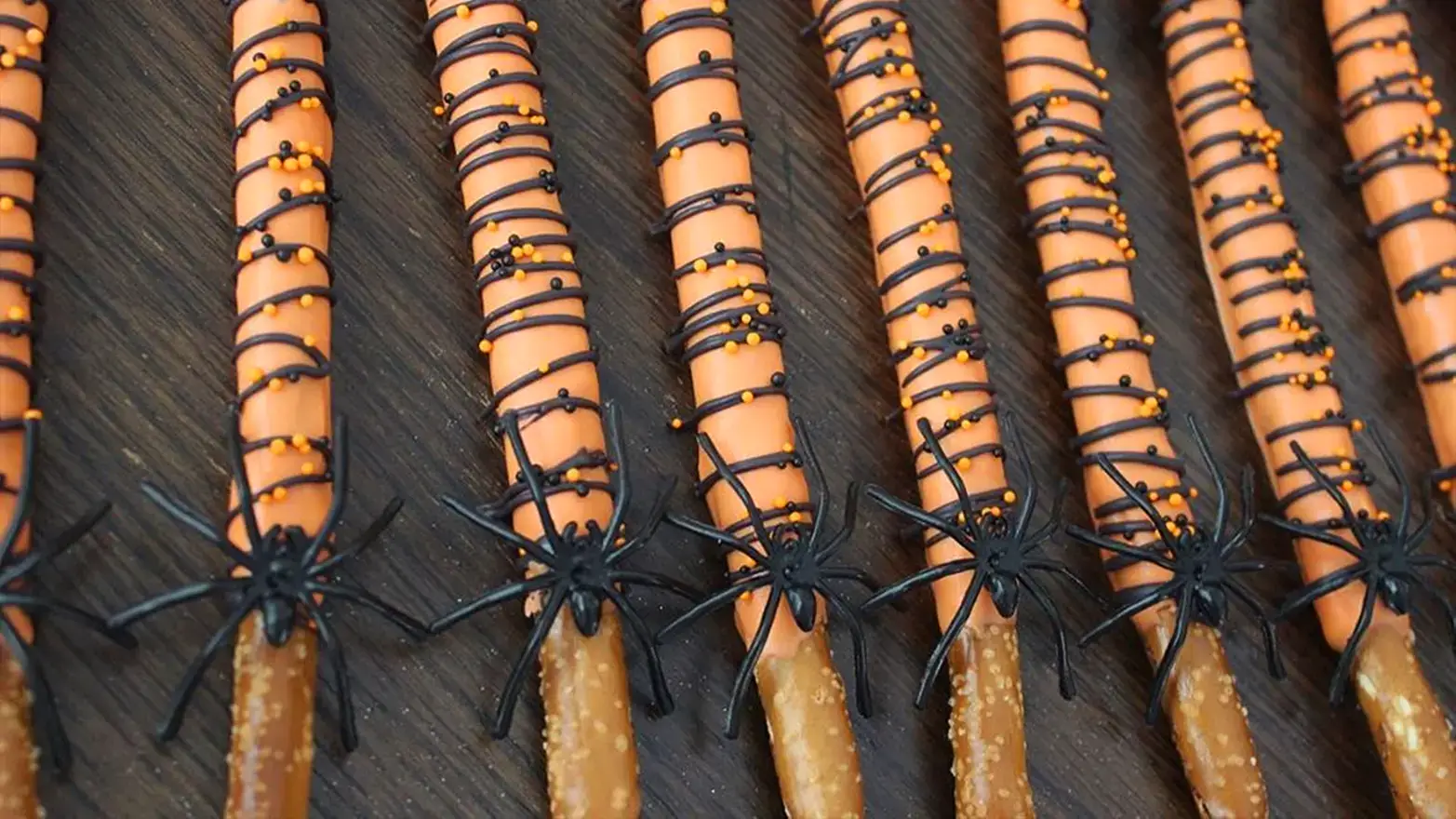 Chocolate dipped pretzels with plastic spiders