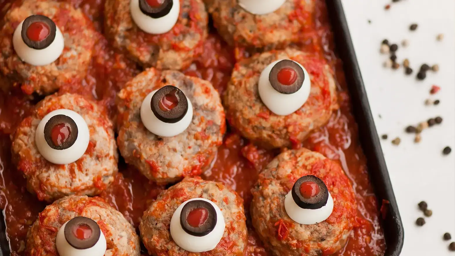 Meatballs with mozzarella and stuffed olive eyes