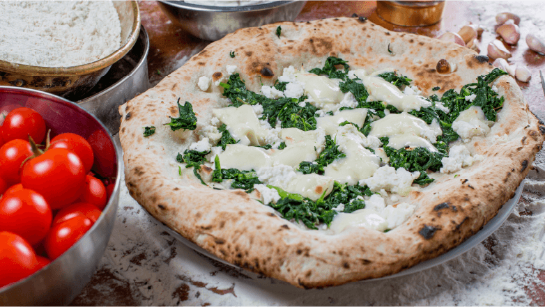 pizza topped with cottage cheese and fresh herbs