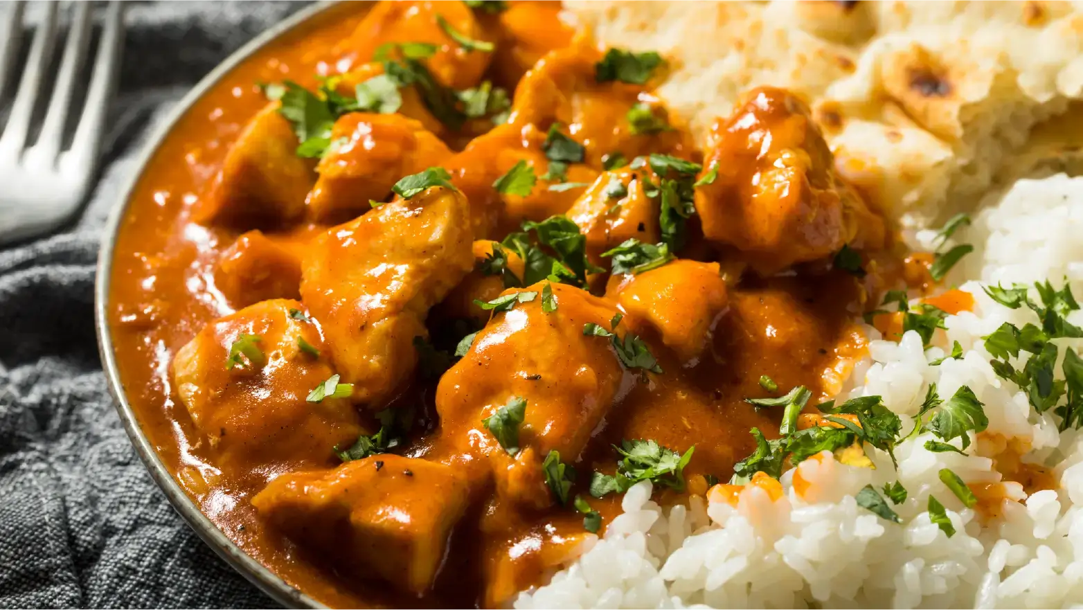 plate of butter chicken with white rice